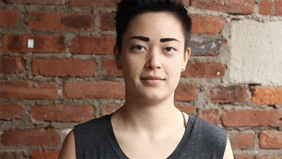 Gif of woman wrapping the Trtl pillow around her neck.